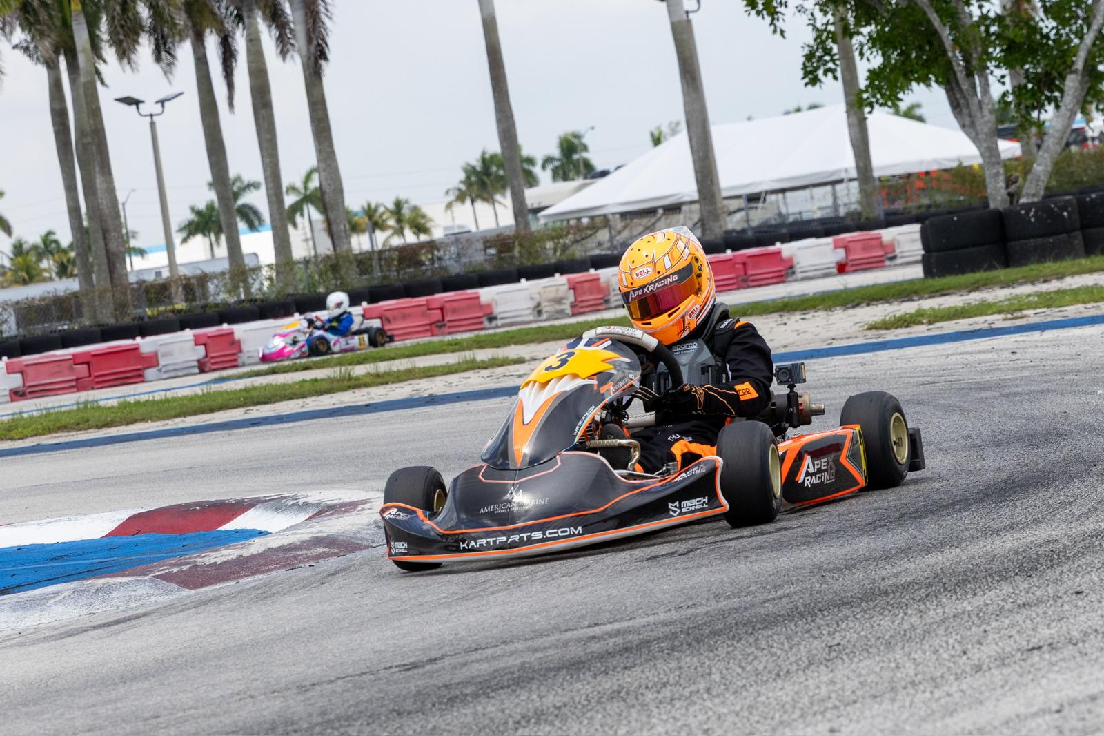 Person driving a go-kart on a track 